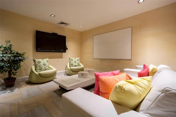 a bedroom with furniture and a flat screen tv