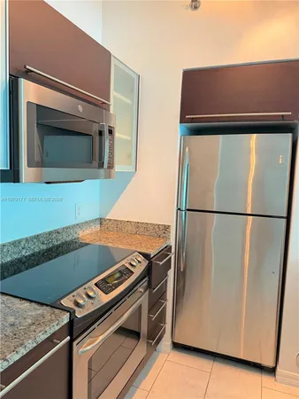 a kitchen with a refrigerator and a microwave