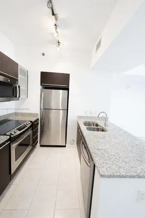 a kitchen with a sink stove and refrigerator