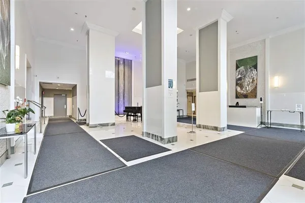 a large white kitchen with stainless steel appliances kitchen island granite countertop a refrigerator and a sink