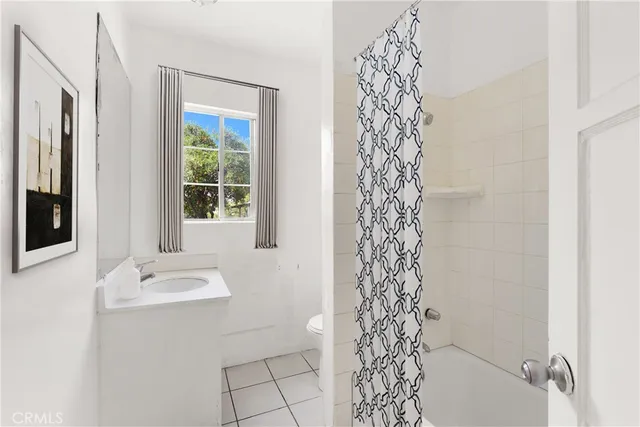 a bathroom with a bathtub a sink and a window