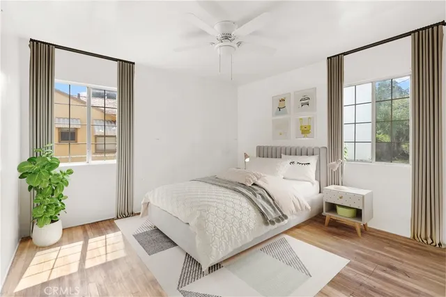 a bedroom with a bed table and a window