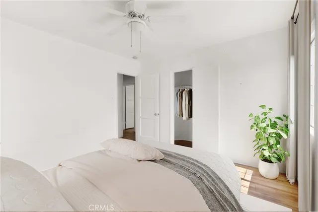 a bedroom with a bed and a potted plant