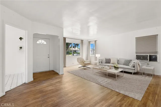 a living room with furniture wooden floor and a fireplace