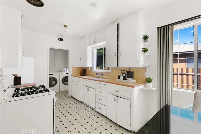 a kitchen with sink cabinets and appliances
