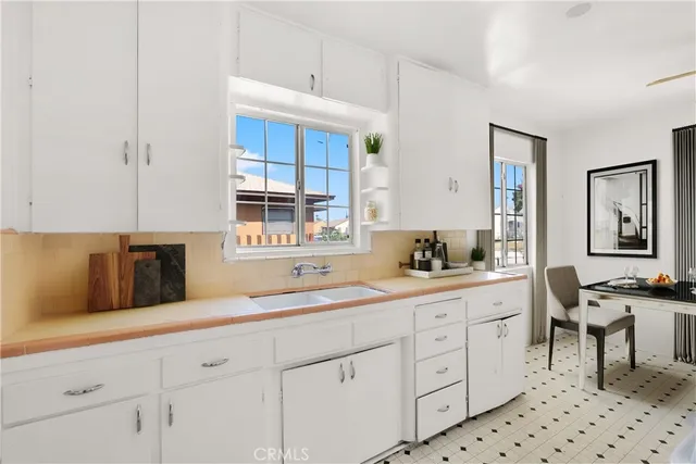 a kitchen with sink cabinets and stove