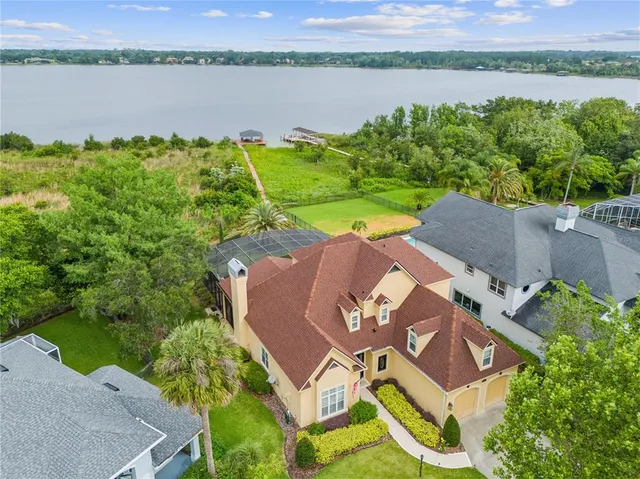 an aerial view of a house with garden space and lake view