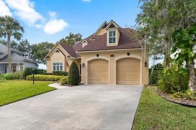 a front view of a house with a yard and garage