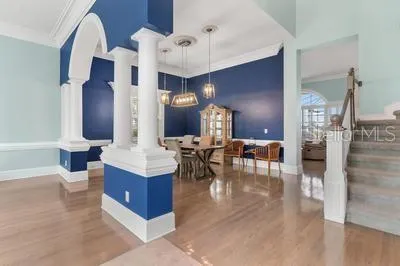 a view of a dining room with furniture and a chandelier