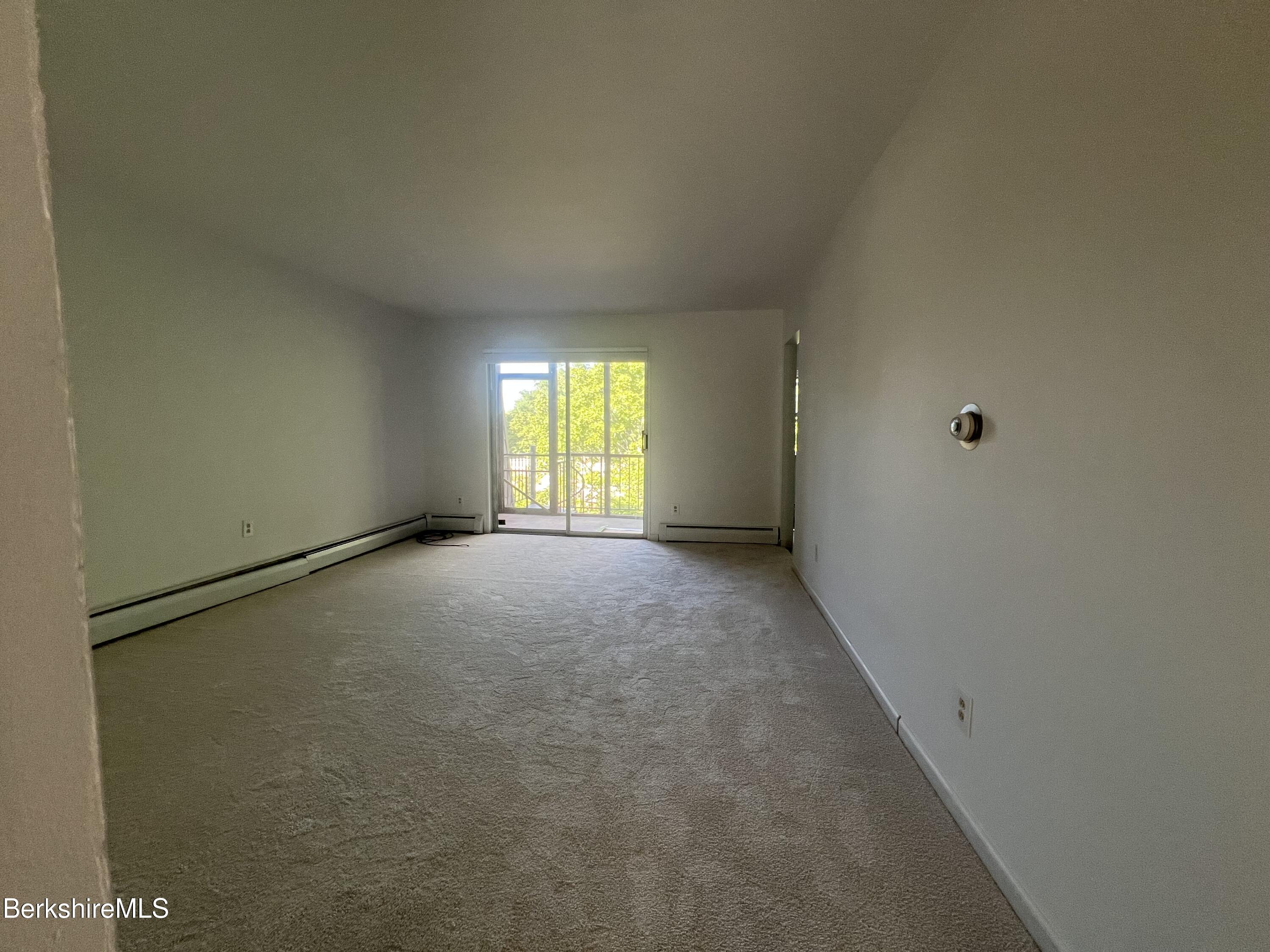 260 Pittsfield Road, Unit B5 Lenox, MA 01240 - Photo 6 of 13 a view of an empty room with a window