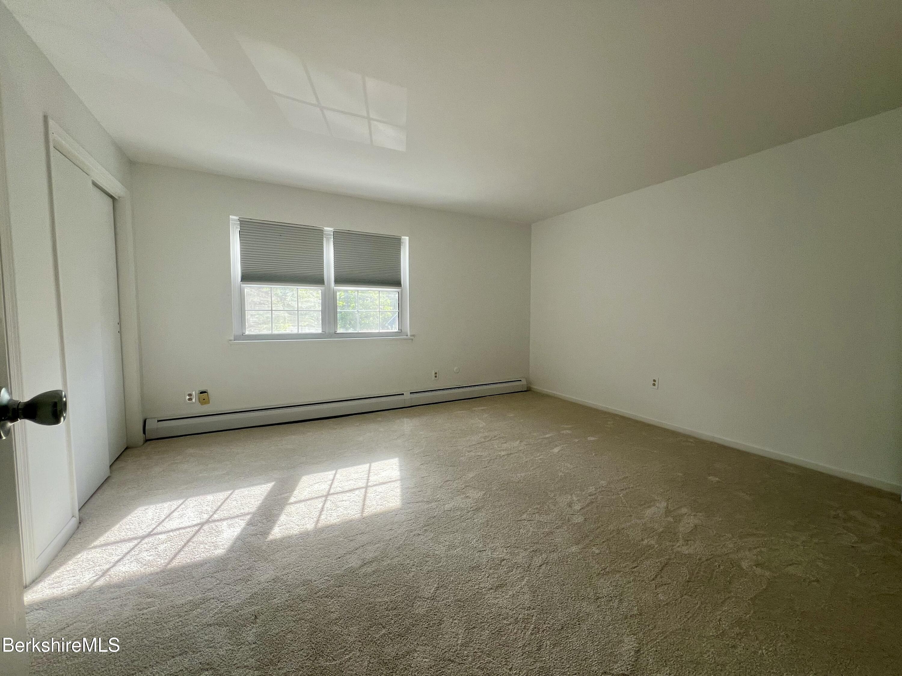 260 Pittsfield Road, Unit B5 Lenox, MA 01240 - Photo 7 of 13 an empty room with a window