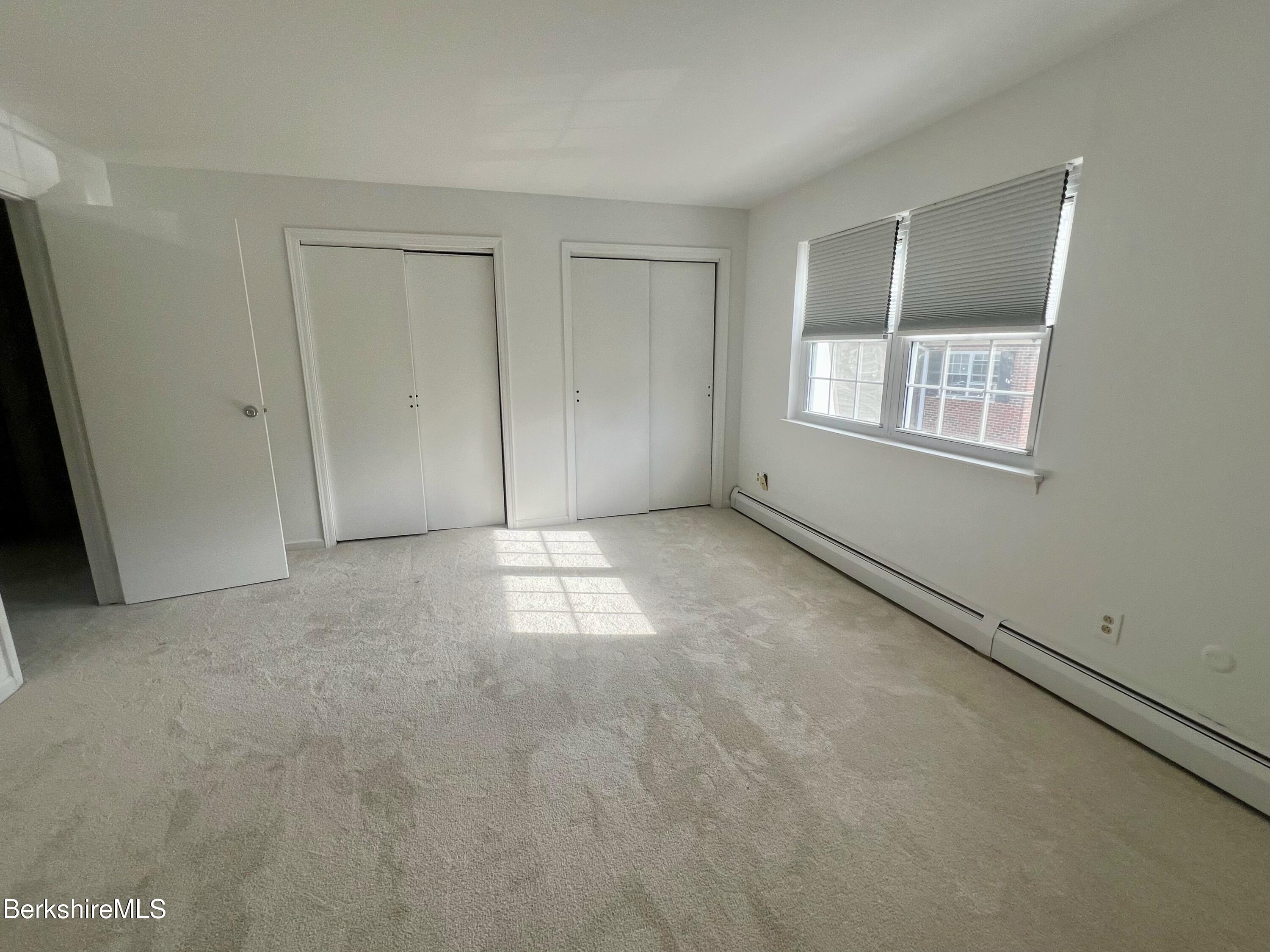 260 Pittsfield Road, Unit B5 Lenox, MA 01240 - Photo 8 of 13 a view of an empty room with a window