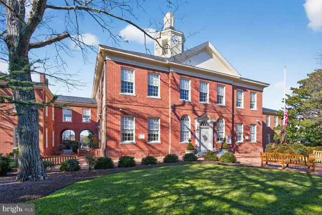a large building with a swimming pool in front of it