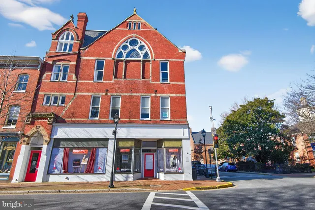 a view of a house with a wooden fence
