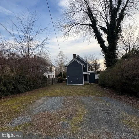 a view of a house with a yard covered in snow