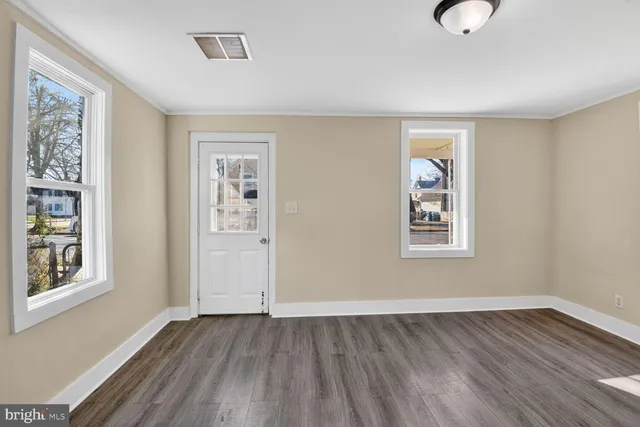 a view of a livingroom with wooden floor and a window