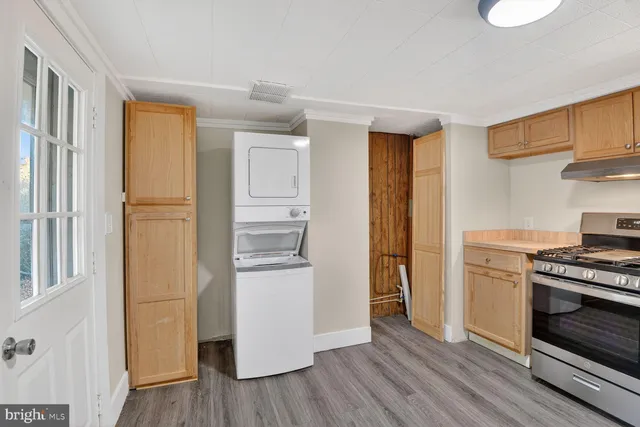 a kitchen with a refrigerator and a stove top oven