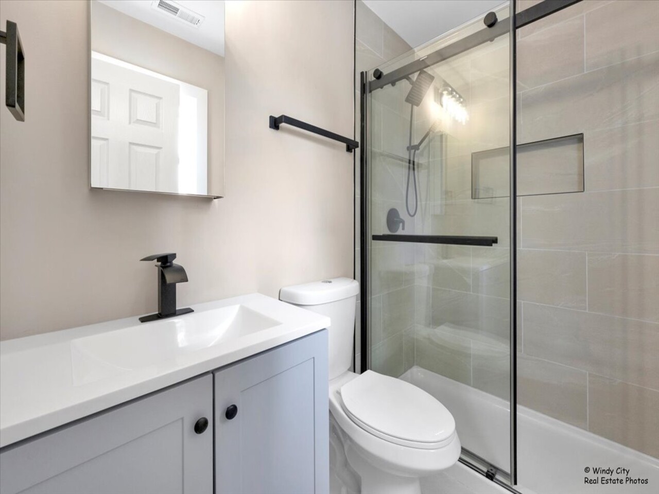 203 Elm Lane Streamwood, IL 60107 - Photo 12 of 23 a bathroom with a sink a toilet and shower