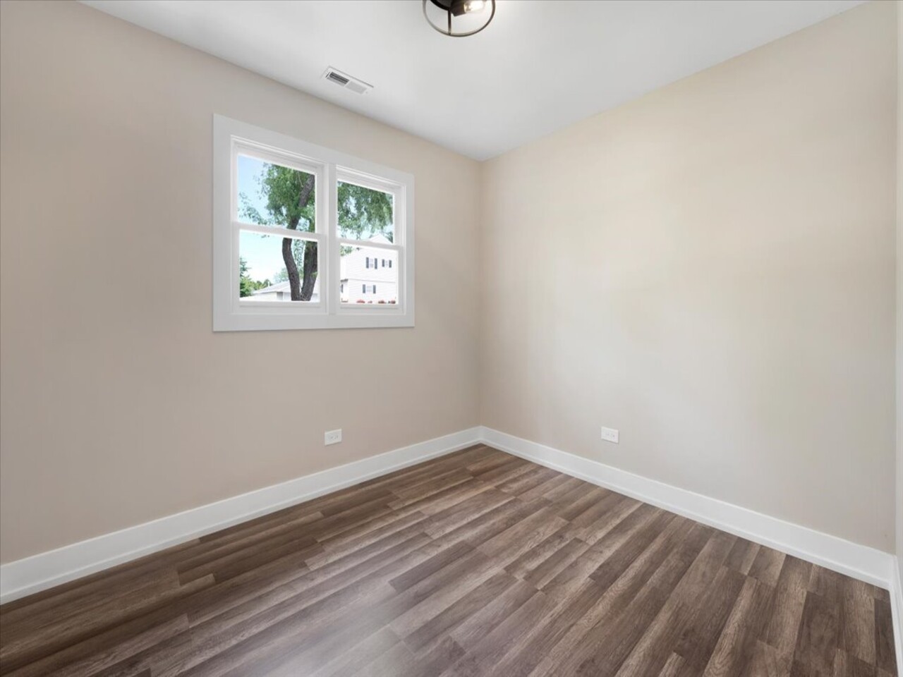 203 Elm Lane Streamwood, IL 60107 - Photo 14 of 23 a view of an empty room with wooden floor and a window