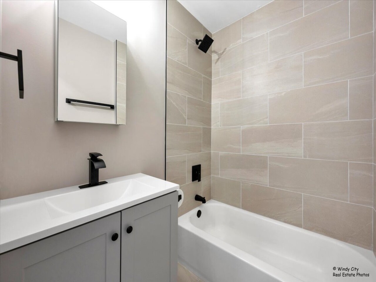 203 Elm Lane Streamwood, IL 60107 - Photo 16 of 23 a bathroom with a sink a bathtub and a shower