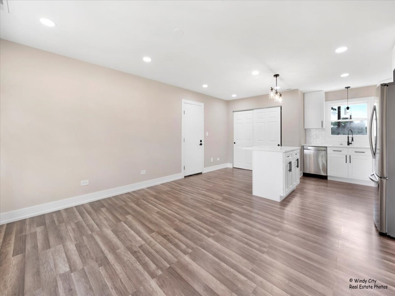 203 Elm Lane Streamwood, IL 60107 - Photo 2 of 23 a view of a kitchen with wooden floor and a sink