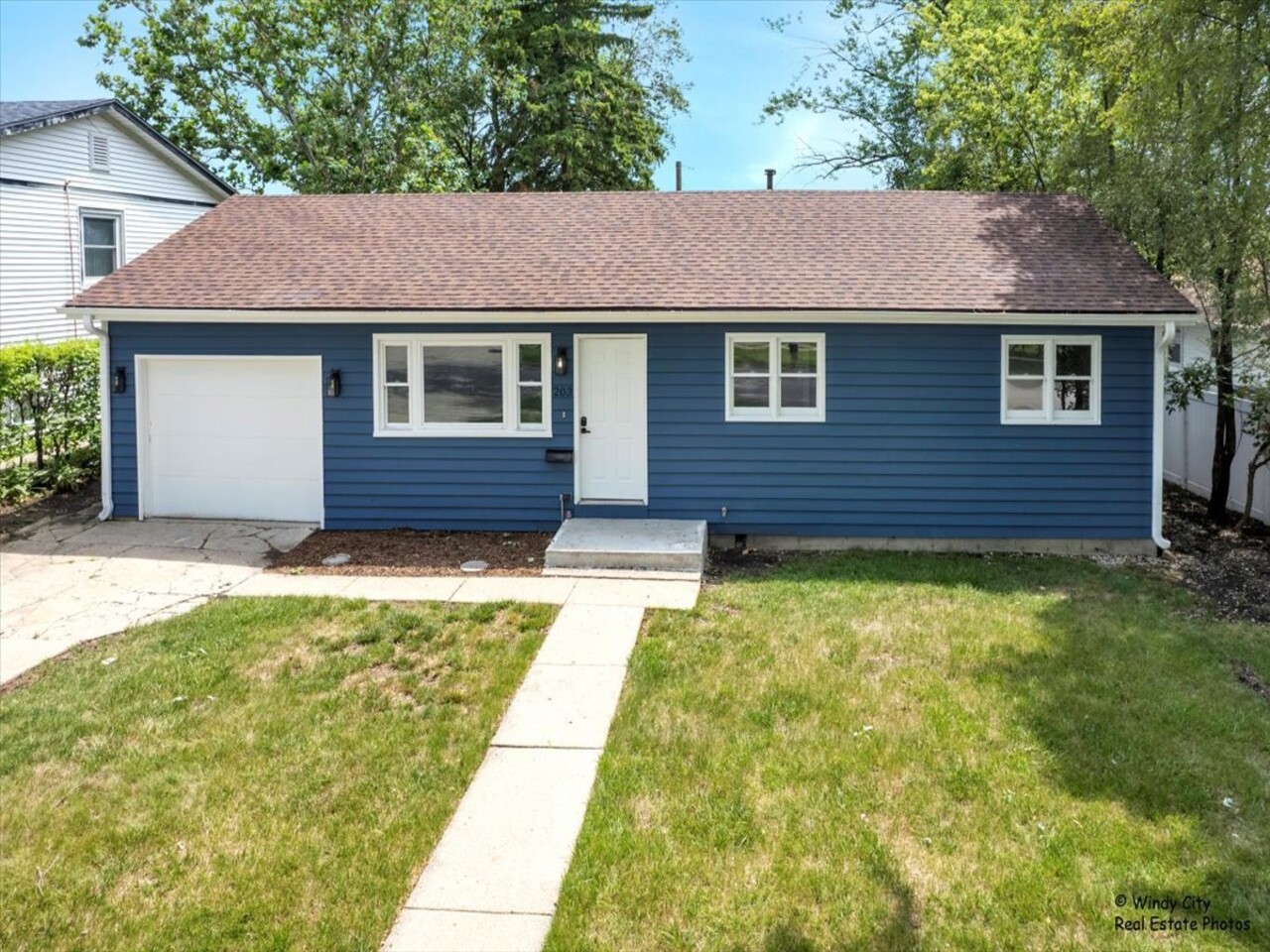 203 Elm Lane Streamwood, IL 60107 - Photo 22 of 23 a front view of a house with a garden