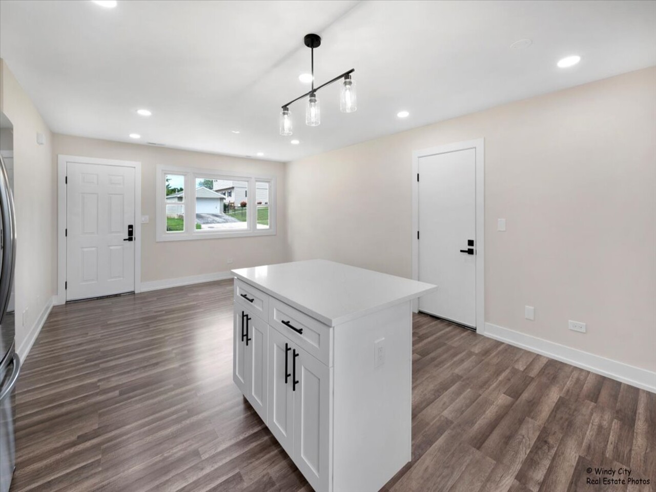 203 Elm Lane Streamwood, IL 60107 - Photo 8 of 23 wooden floor in an empty room with a stove