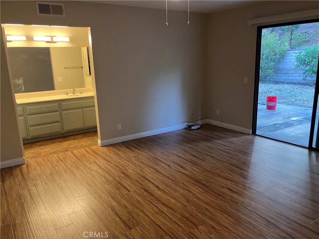 19933 Ralph Street Walnut, CA 91789 - Photo 37 of 77 a view of an empty room with wooden floor and a window