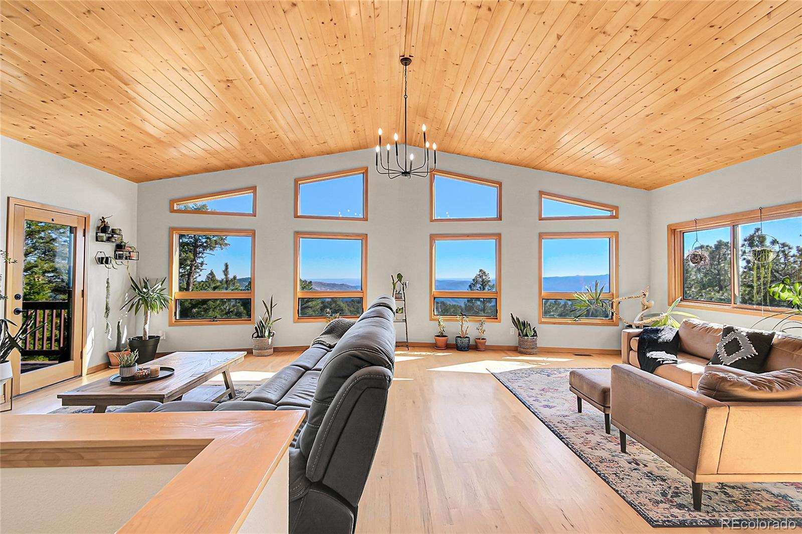 a view of a livingroom with furniture and floor to ceiling window