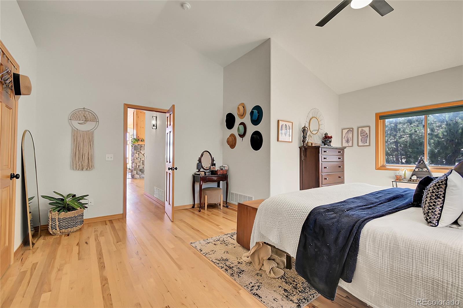 13382 Riley Peak Road Conifer, CO 80433 - Photo 14 of 25 a bedroom with a bed and a large window