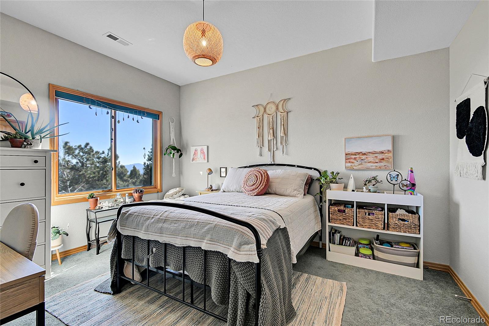 13382 Riley Peak Road Conifer, CO 80433 - Photo 17 of 25 a bedroom with a bed and a table in it