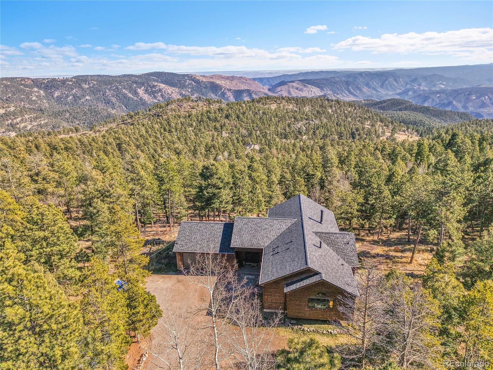 13382 Riley Peak Road Conifer, CO 80433 - Photo 2 of 25 an aerial view of residential houses with outdoor space and trees