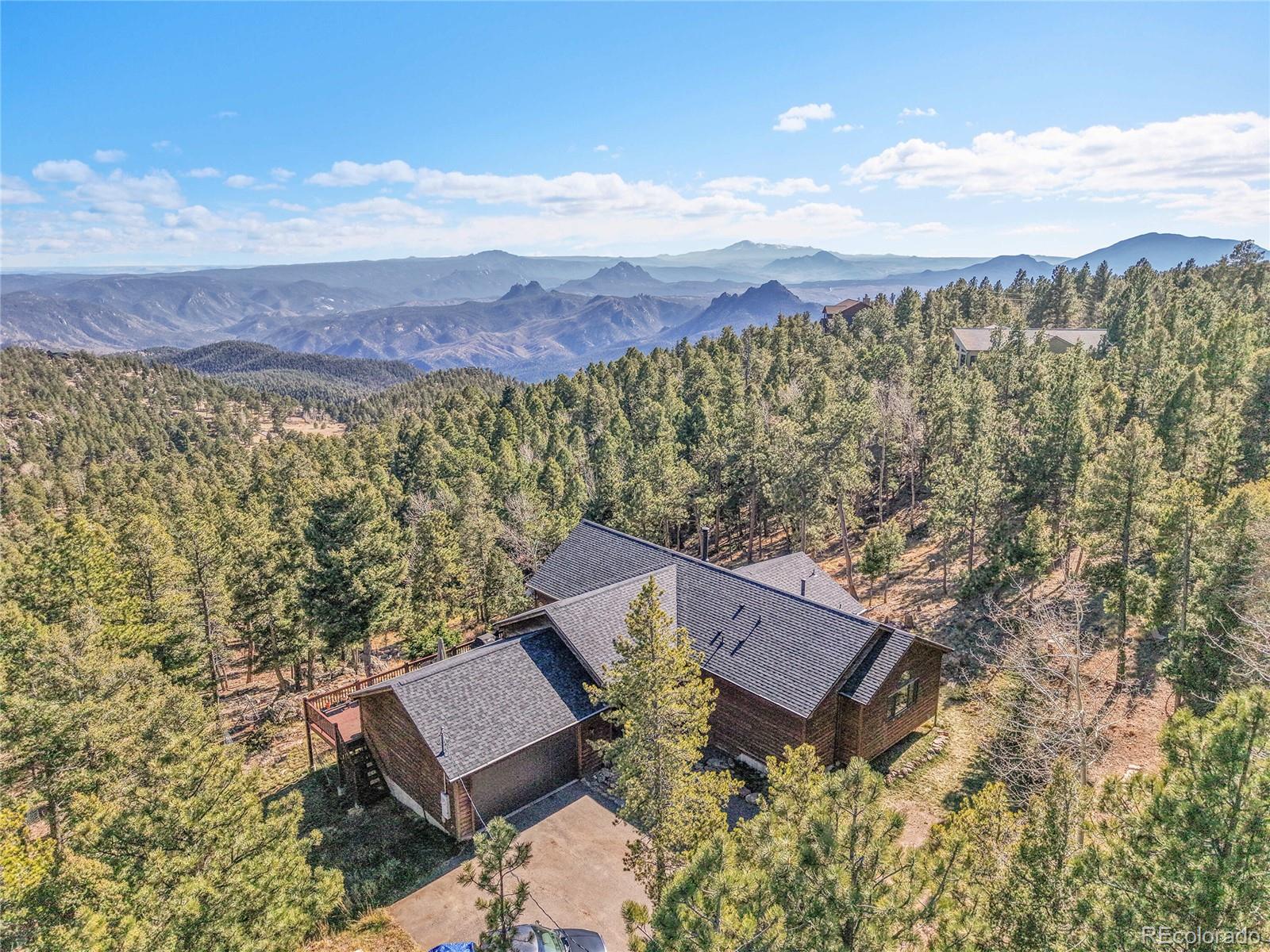13382 Riley Peak Road Conifer, CO 80433 - Photo 6 of 25 an aerial view of a house with a yard and mountain view
