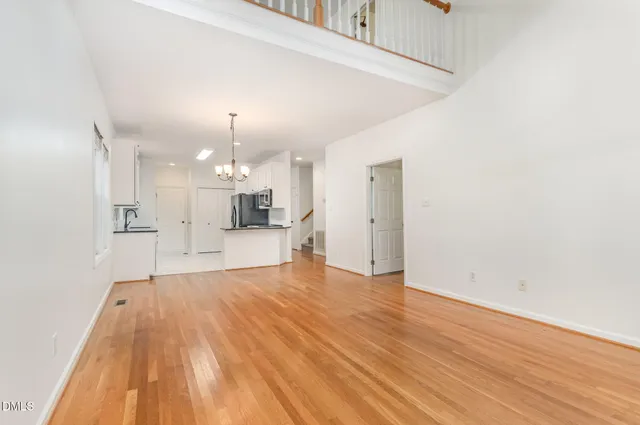 a view of a kitchen with wooden floor and a window