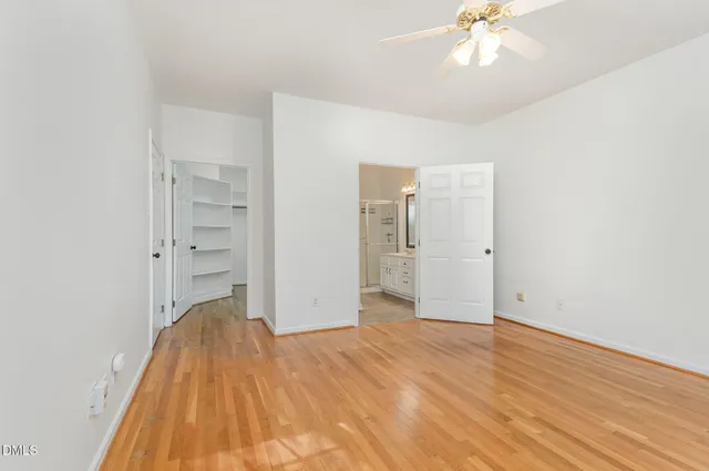 an empty room with wooden floor and closet