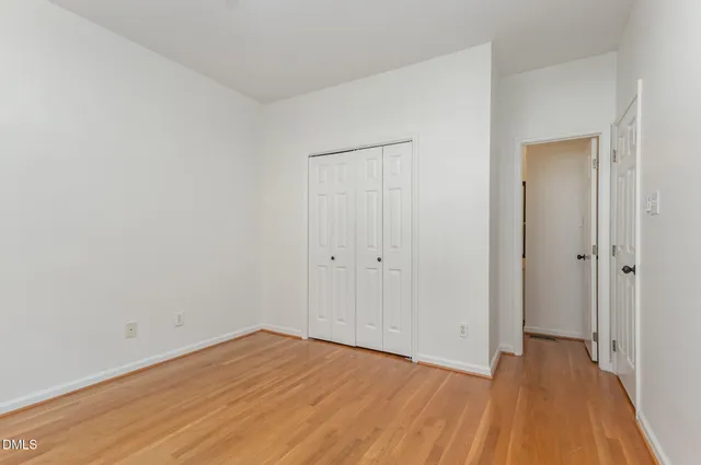 a view of an empty room and wooden floor