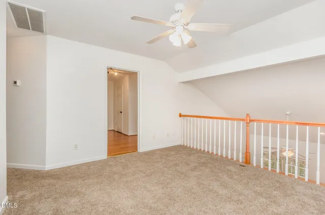 a view of a hallway with a ceiling fan