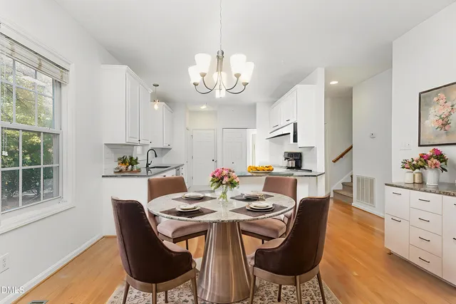 a view of a dining room with furniture and chandelier