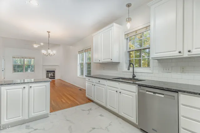 a kitchen that has a sink and cabinets