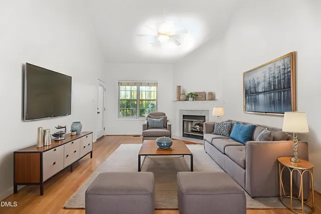 a living room with furniture flat screen tv and a fireplace