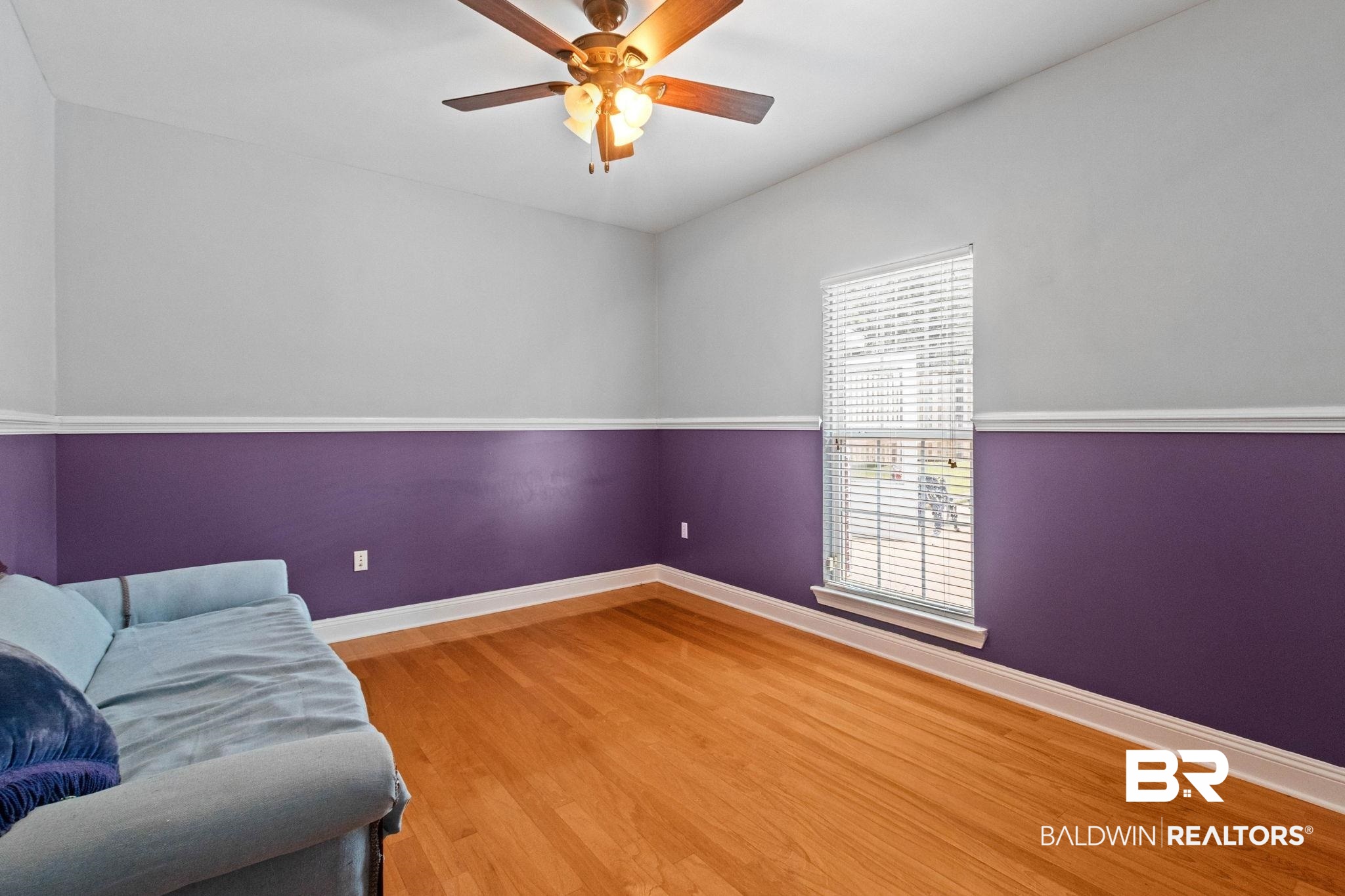 79 Whitetail Run Chatom, AL 36518 - Photo 47 of 82 Hardwood-style flooring in a room featuring a window with blinds, a ceiling fan with integrated lighting, and walls with chair rail molding