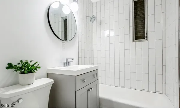 a bathroom with a sink toilet and a mirror