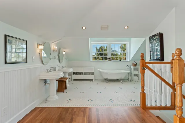 a front view of a building with a garden and plants