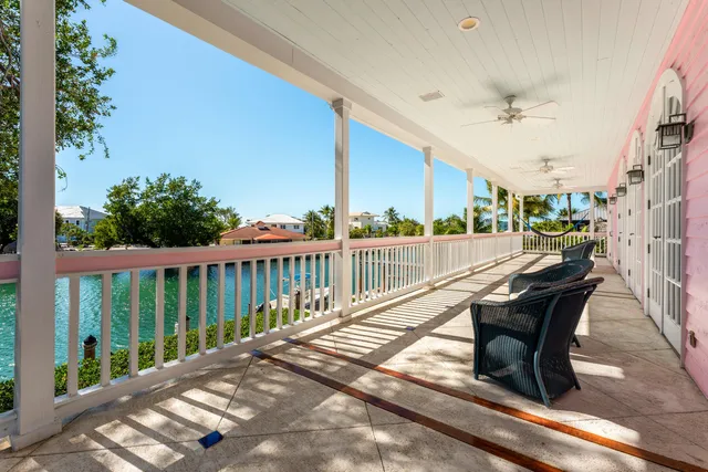 a view of balcony with wooden floor and fence