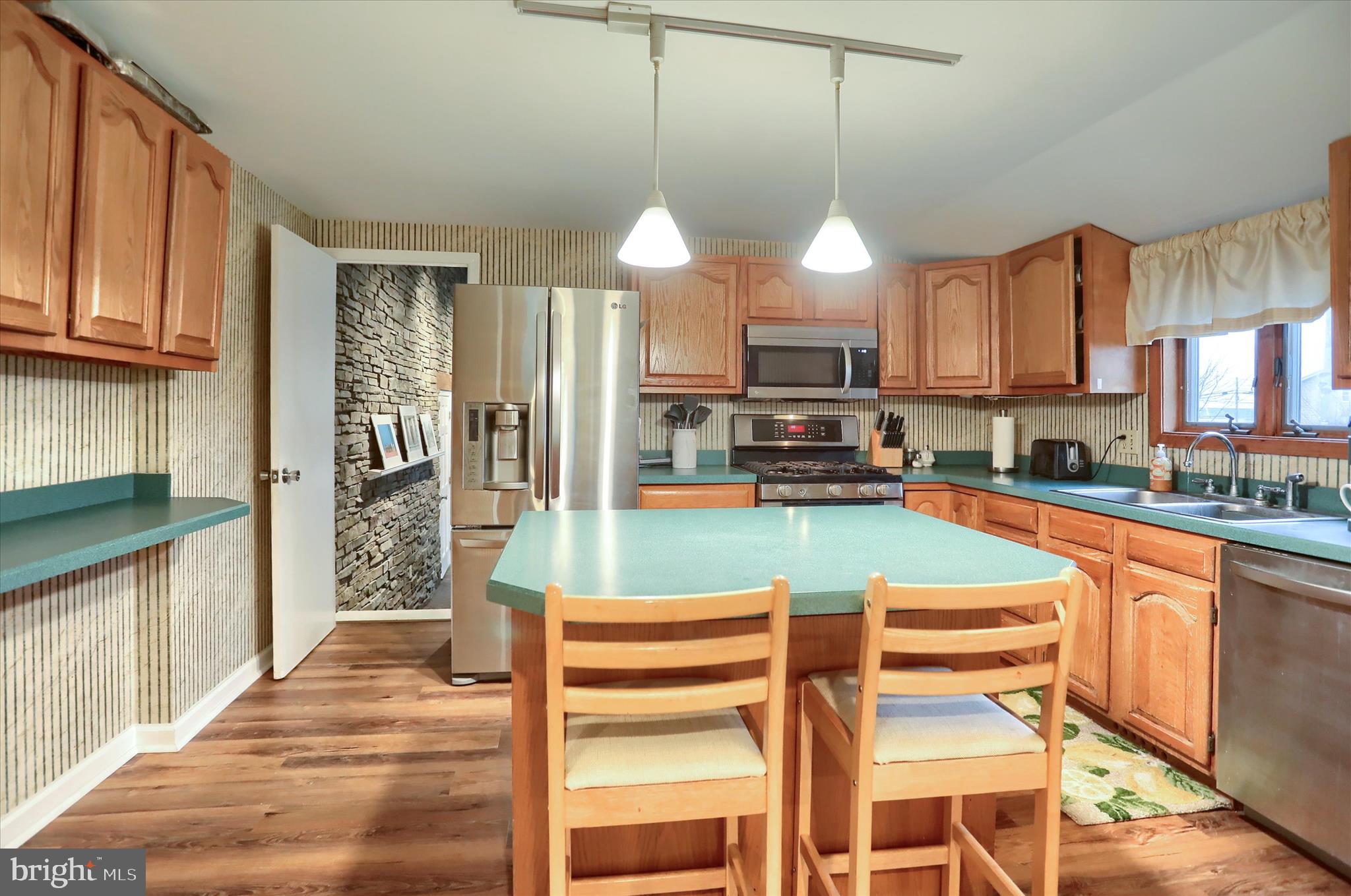 29 Arlene Street Harrisburg, PA 17112 - Photo 11 of 32 a kitchen with stainless steel appliances granite countertop a refrigerator a sink dishwasher a stove and white cabinets with wooden floor