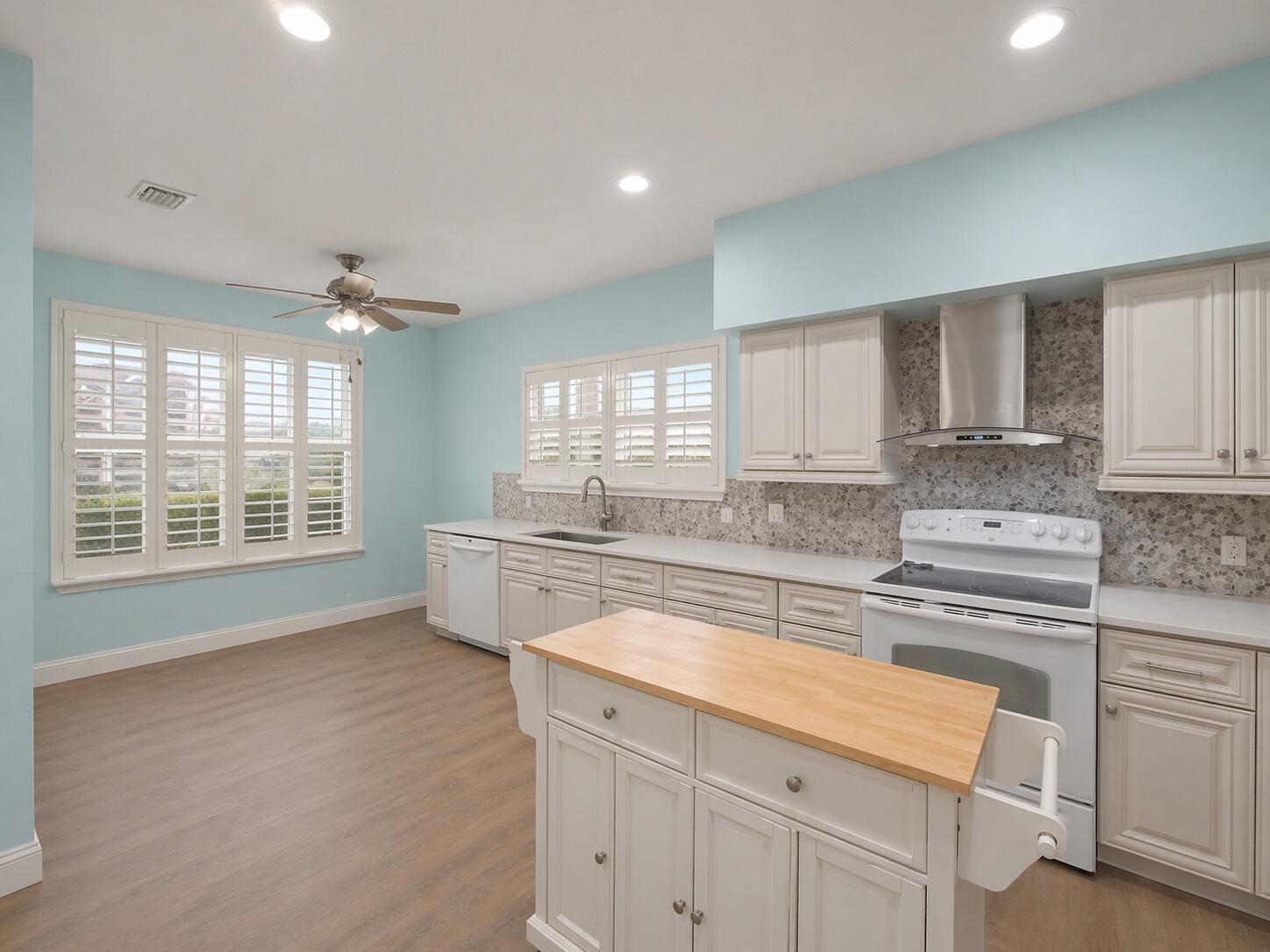3012 Mainsail Circle Jupiter, FL 33477 - Photo 11 of 33 a kitchen with stainless steel appliances granite countertop a stove a sink and white cabinets