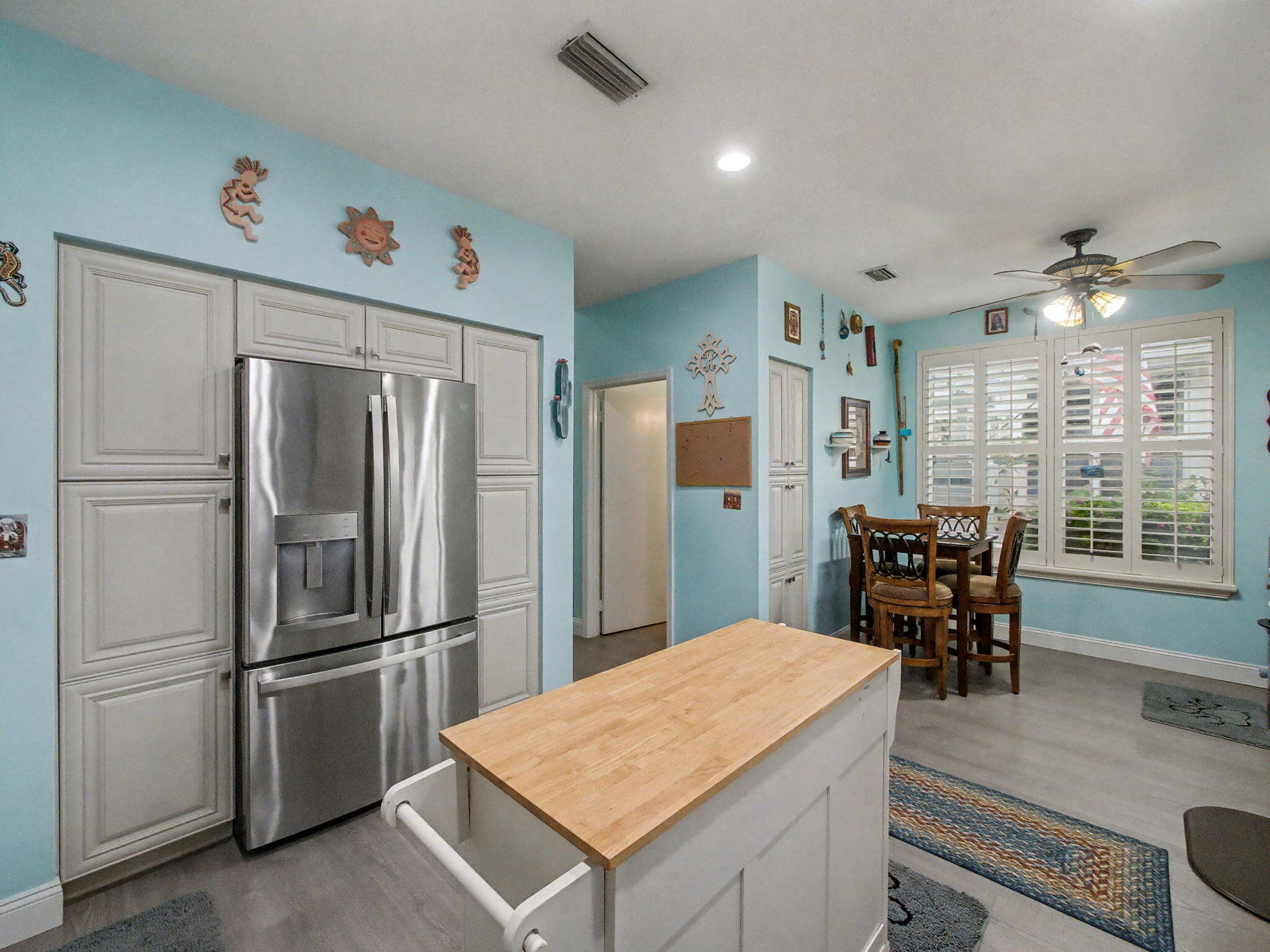 3012 Mainsail Circle Jupiter, FL 33477 - Photo 12 of 33 a kitchen with refrigerator cabinets and wooden floor