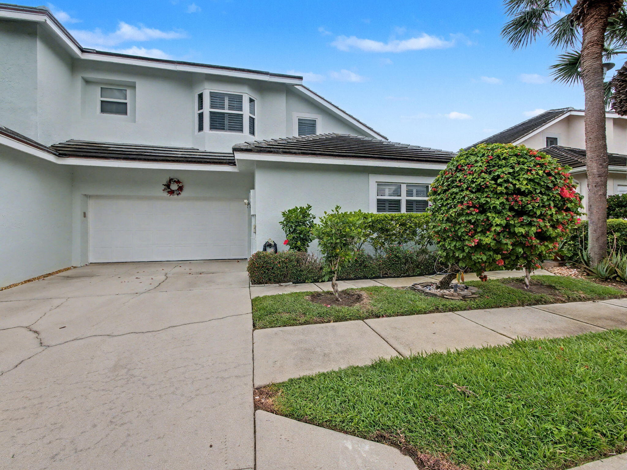 3012 Mainsail Circle Jupiter, FL 33477 - Photo 2 of 33 a front view of house with yard and green space
