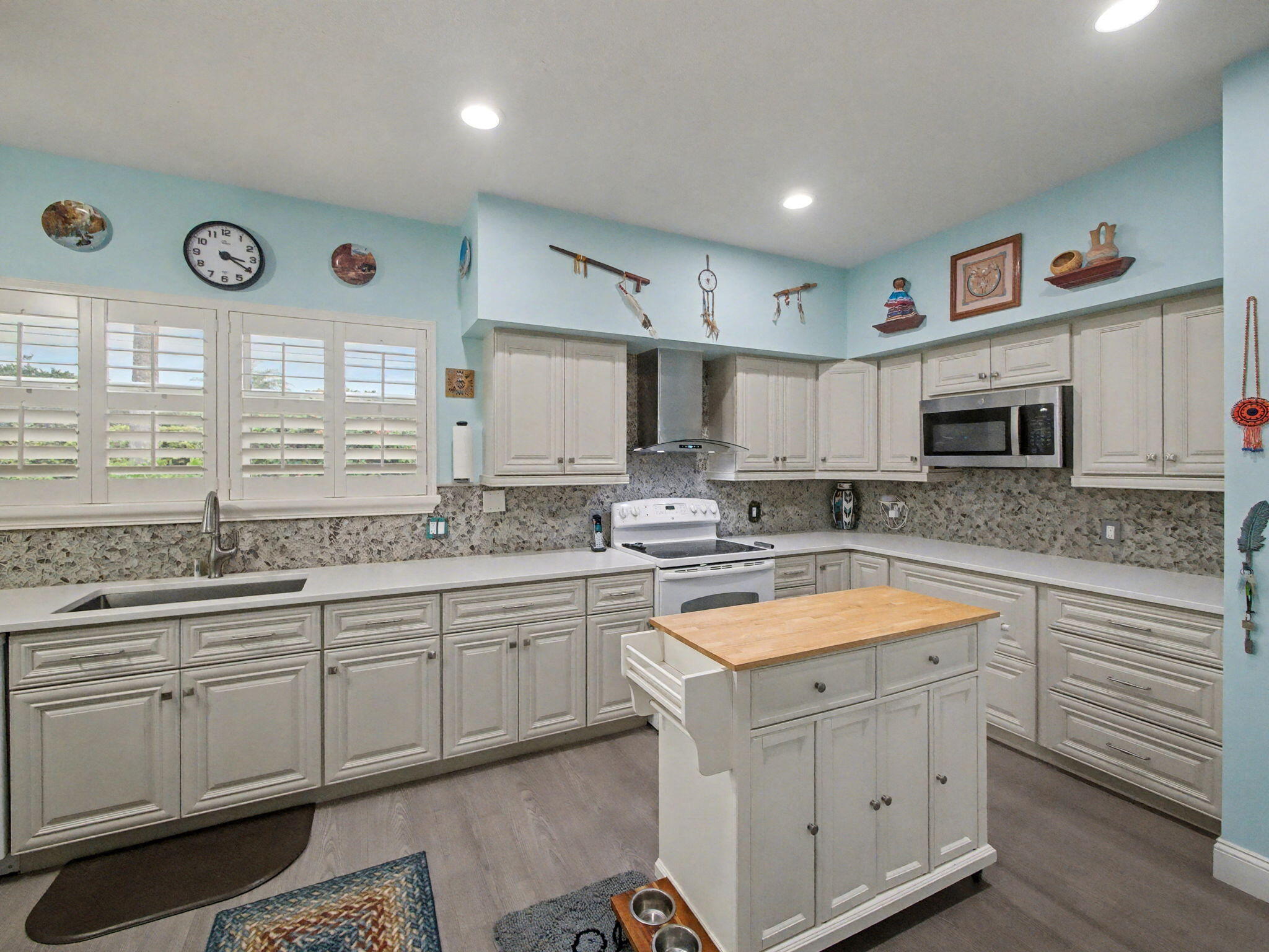 3012 Mainsail Circle Jupiter, FL 33477 - Photo 8 of 33 a kitchen with stainless steel appliances granite countertop a sink and cabinets with wooden floor