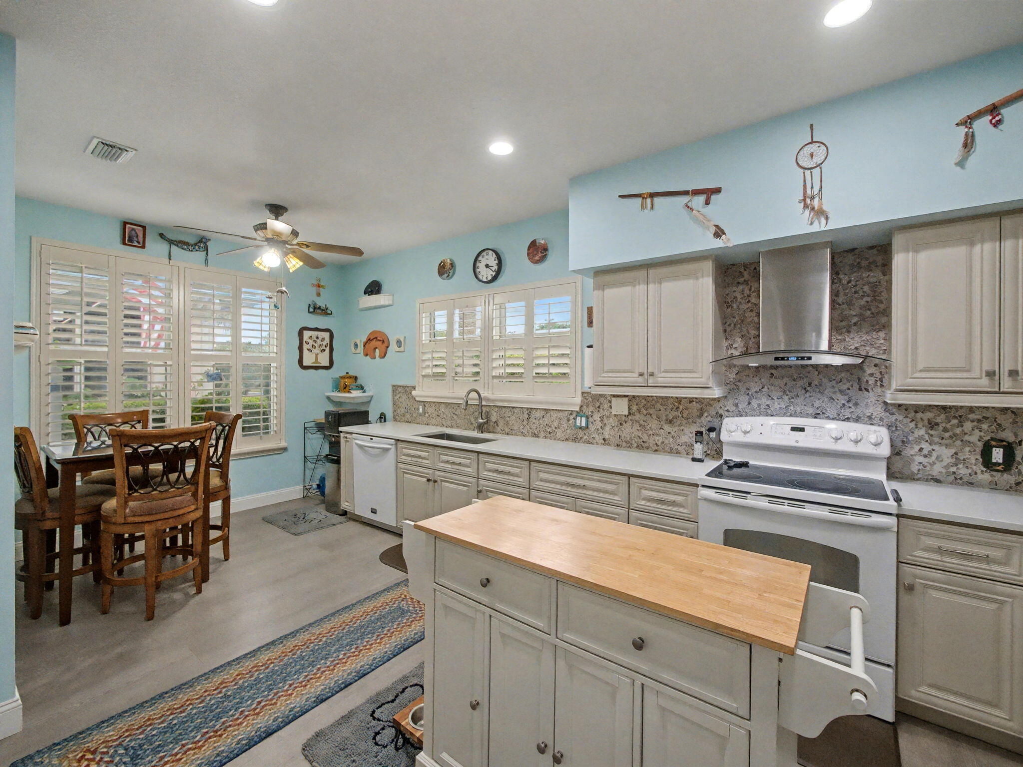 3012 Mainsail Circle Jupiter, FL 33477 - Photo 10 of 33 a kitchen with cabinets and chairs